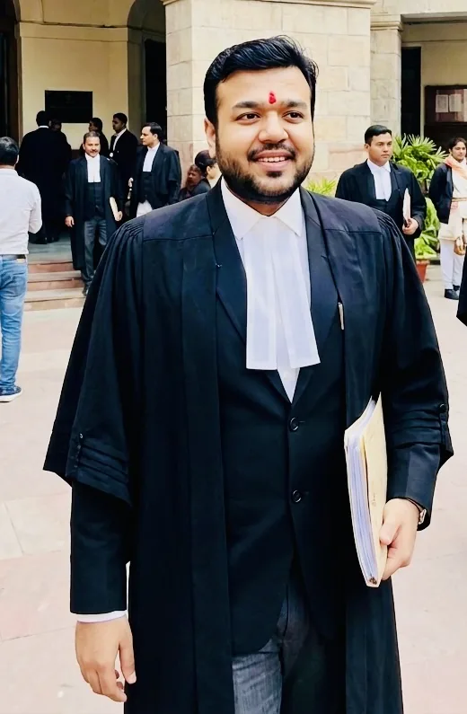 Advocate Aayush Agarwal in advocate robes outside a court building, holding case papers